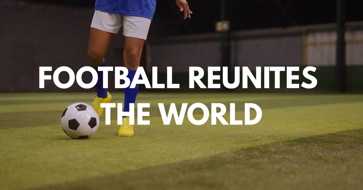 Still from the exbisoft World Cup brand film: a player dribbling a football under the title 'Football Reunites The World'